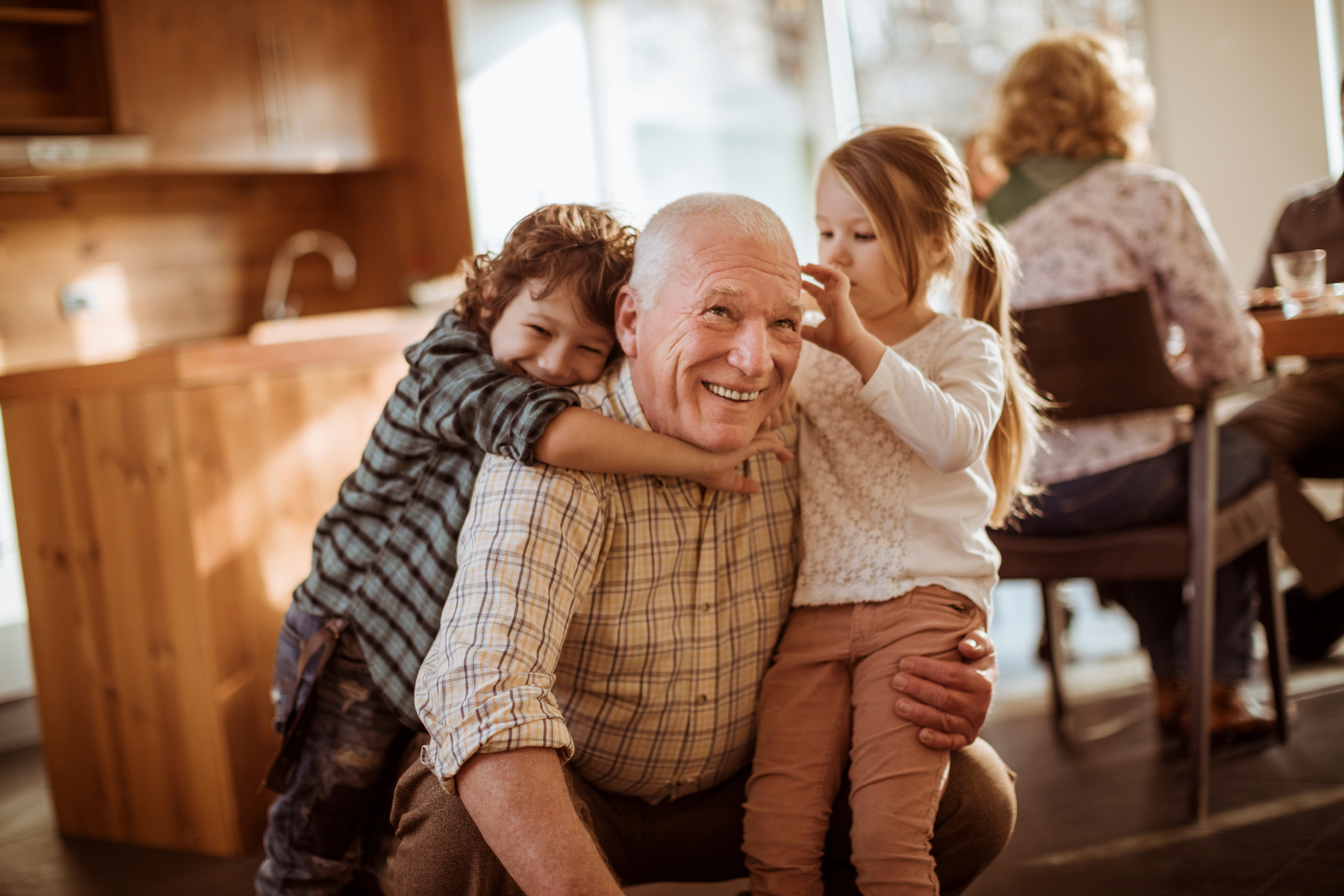 grandfather with 2 small grandkids on lap